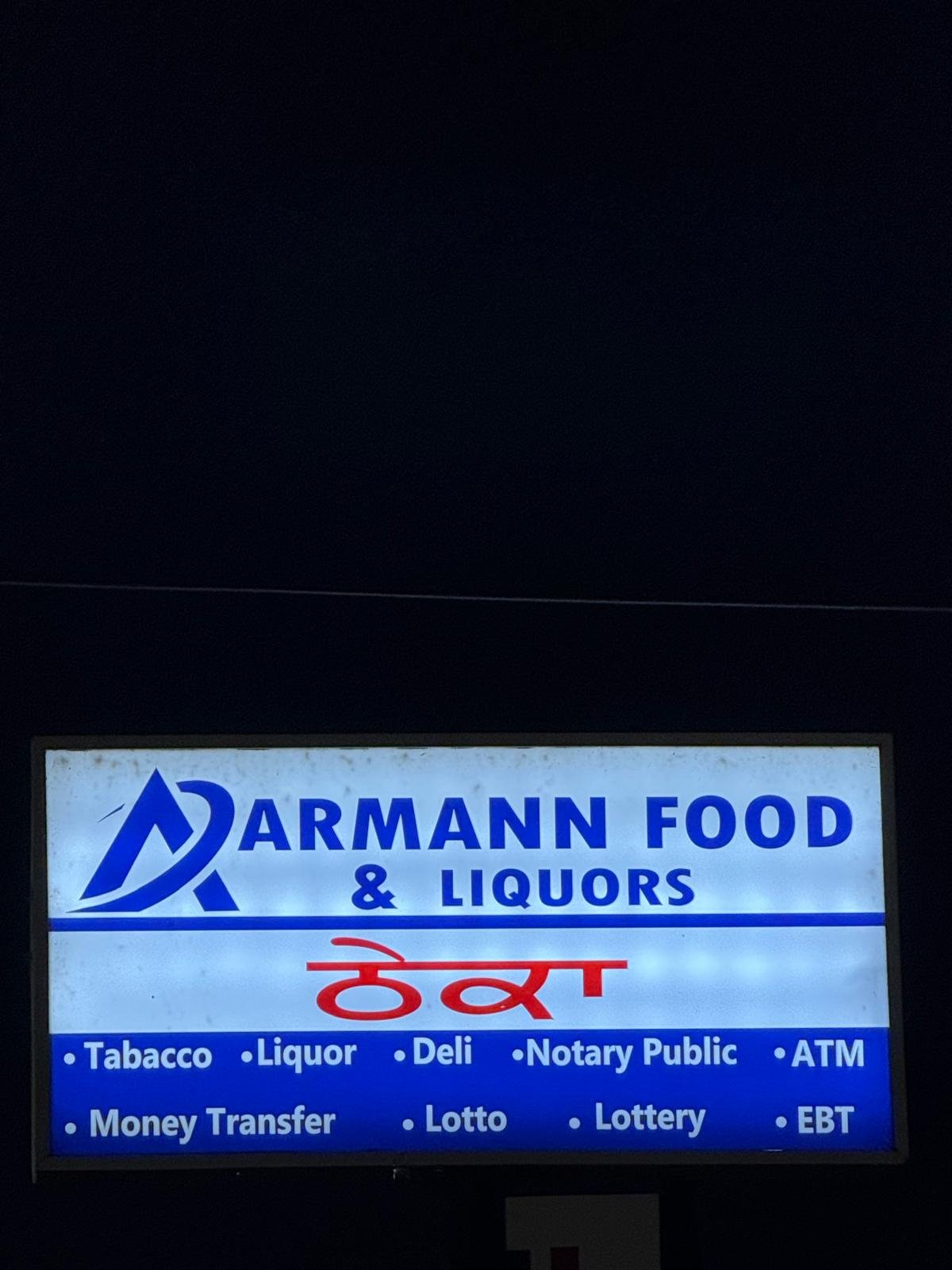 AARMANN Food & Liquors sign at night